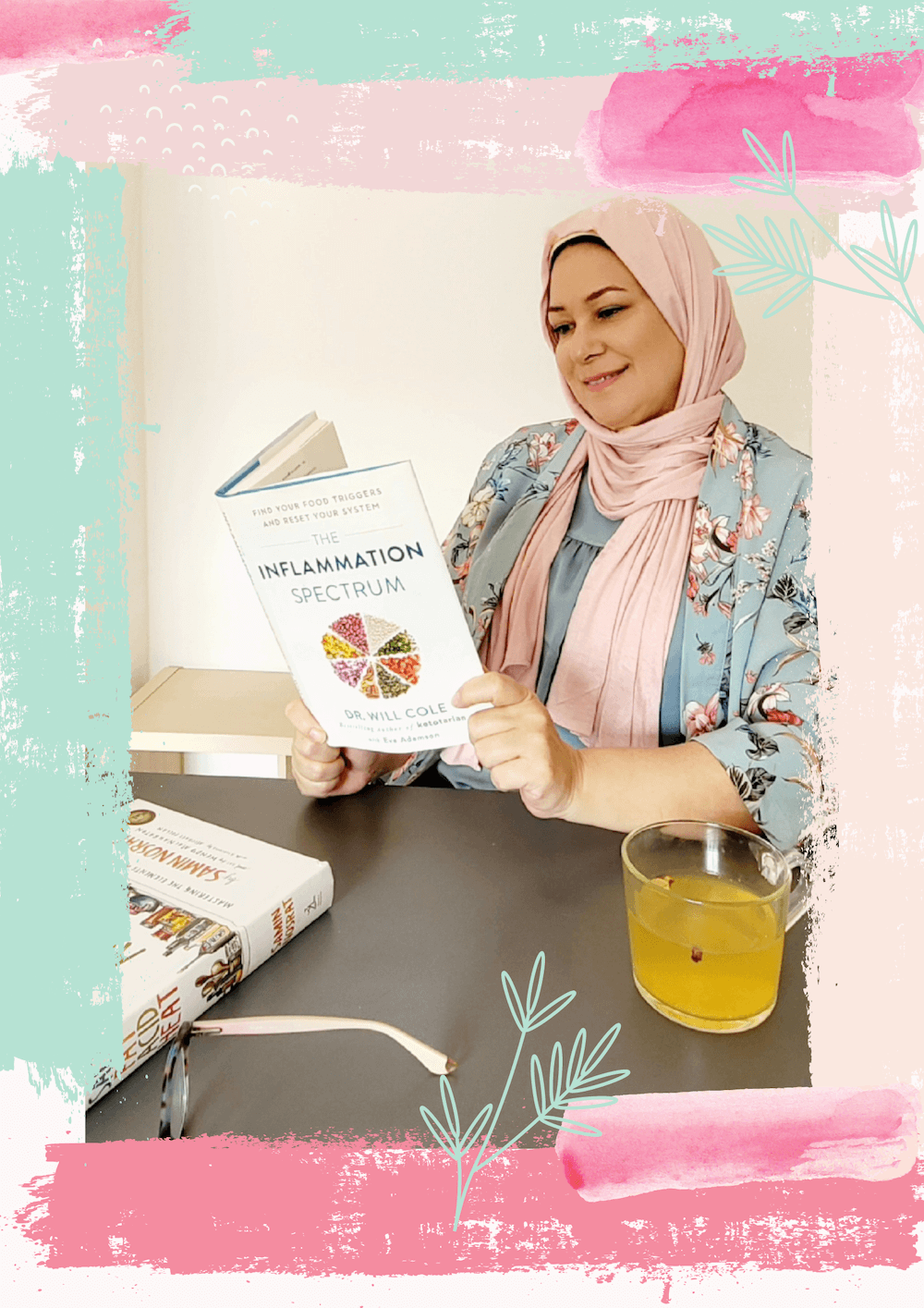 muslim woman sat down at desk reading cook book