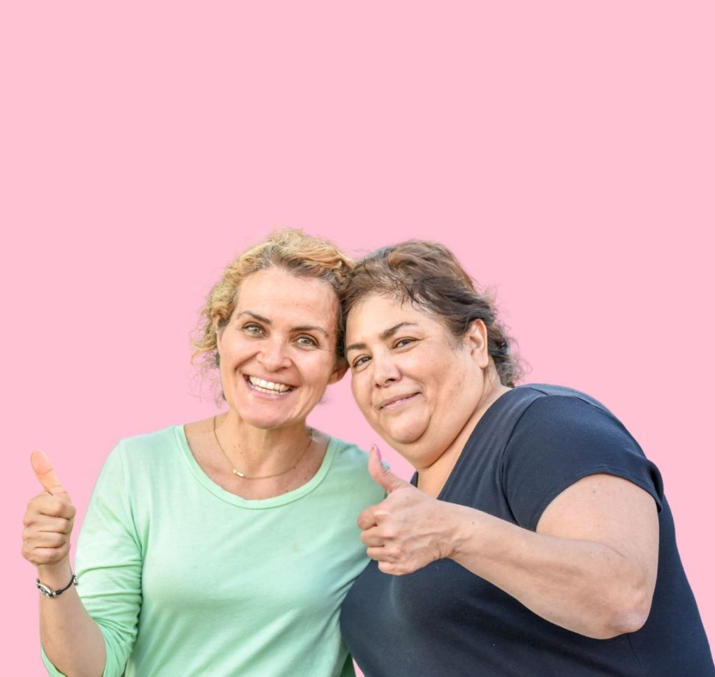 two women holding thumbs up